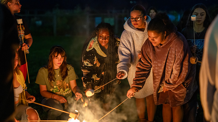 Image of students at campfire.